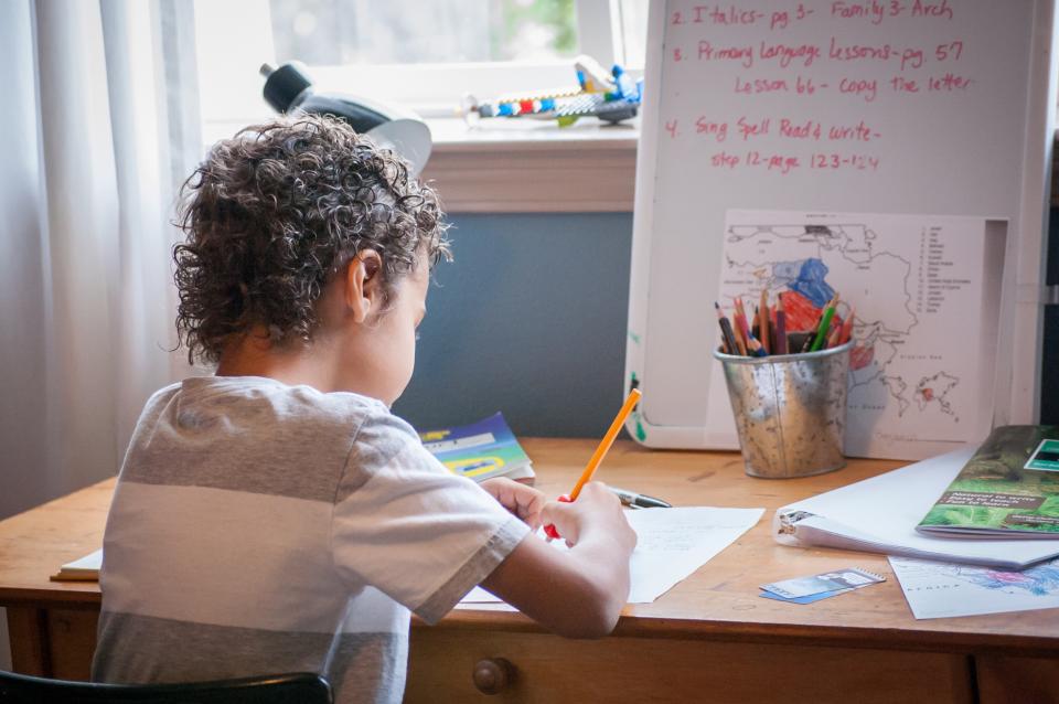 Child writing at desk