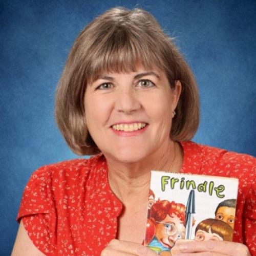 Portrait of Christina Bartell holding the book "Frindle"