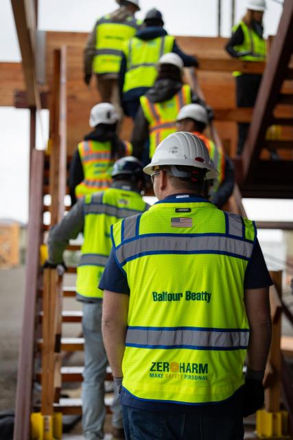 Group in construction gear going up stairs