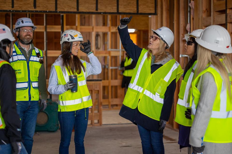 Group in construction gear having a conversation in a room under construction