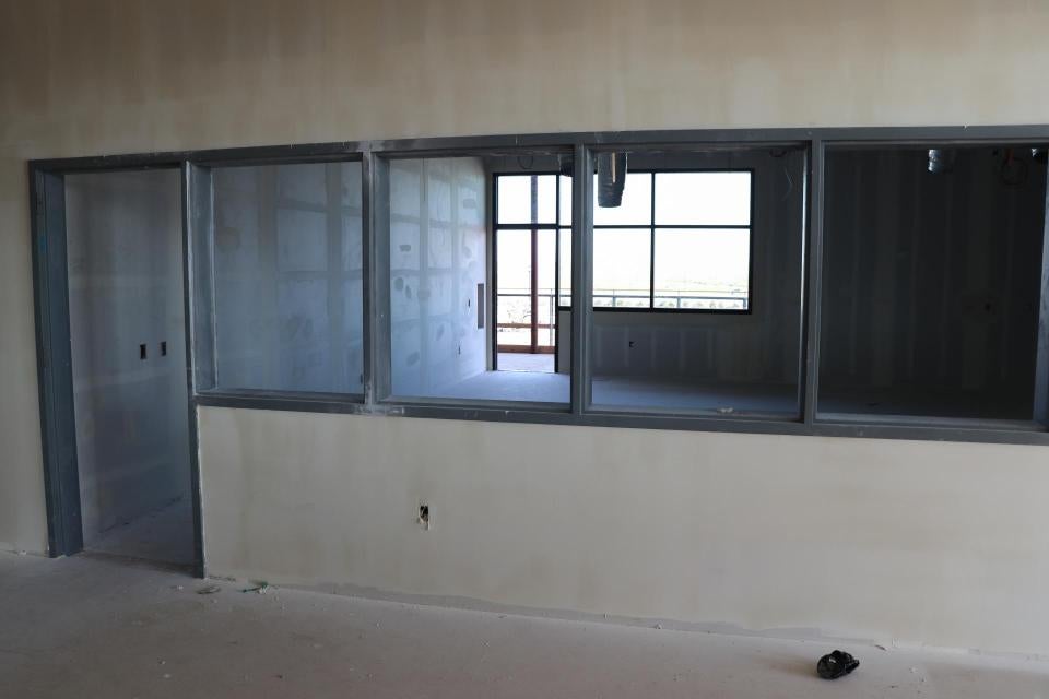 An room under construction seen through interior windows