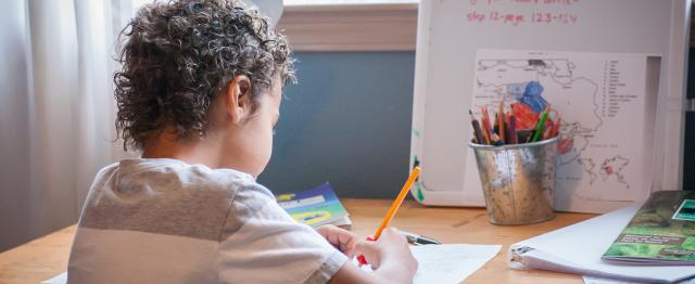 Child writing at desk